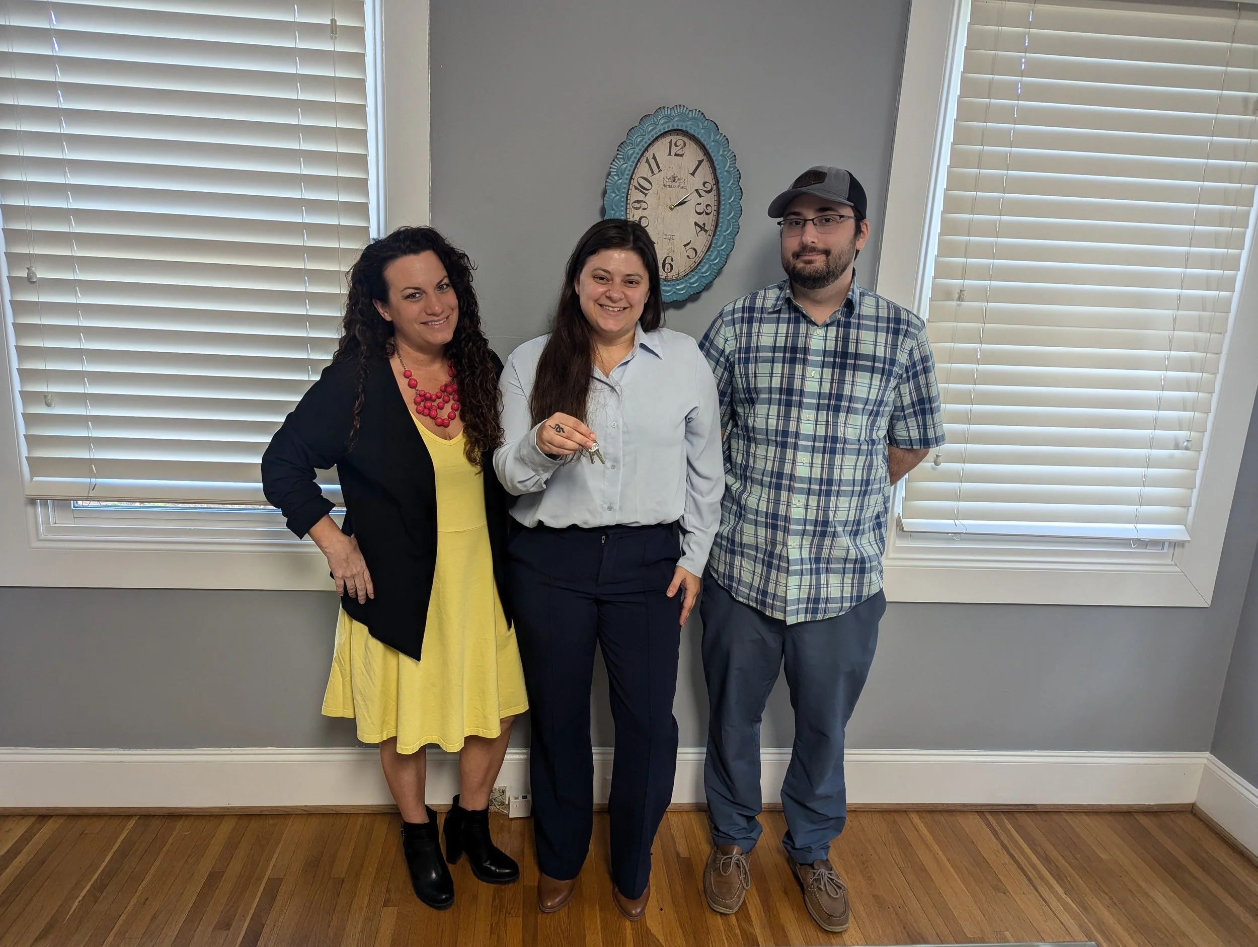 Homebuyers celebrating their new home purchase with Realtor Ashley Calla after closing on an FHA loan in the Charlotte area.