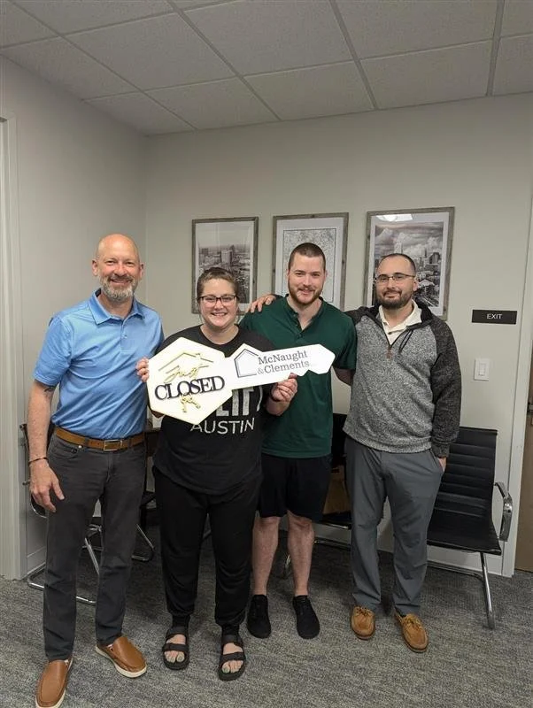 First-time homebuyers celebrating at closing after purchasing a home with a conventional mortgage loan through Carolina Home Financing with Paul Mattos.