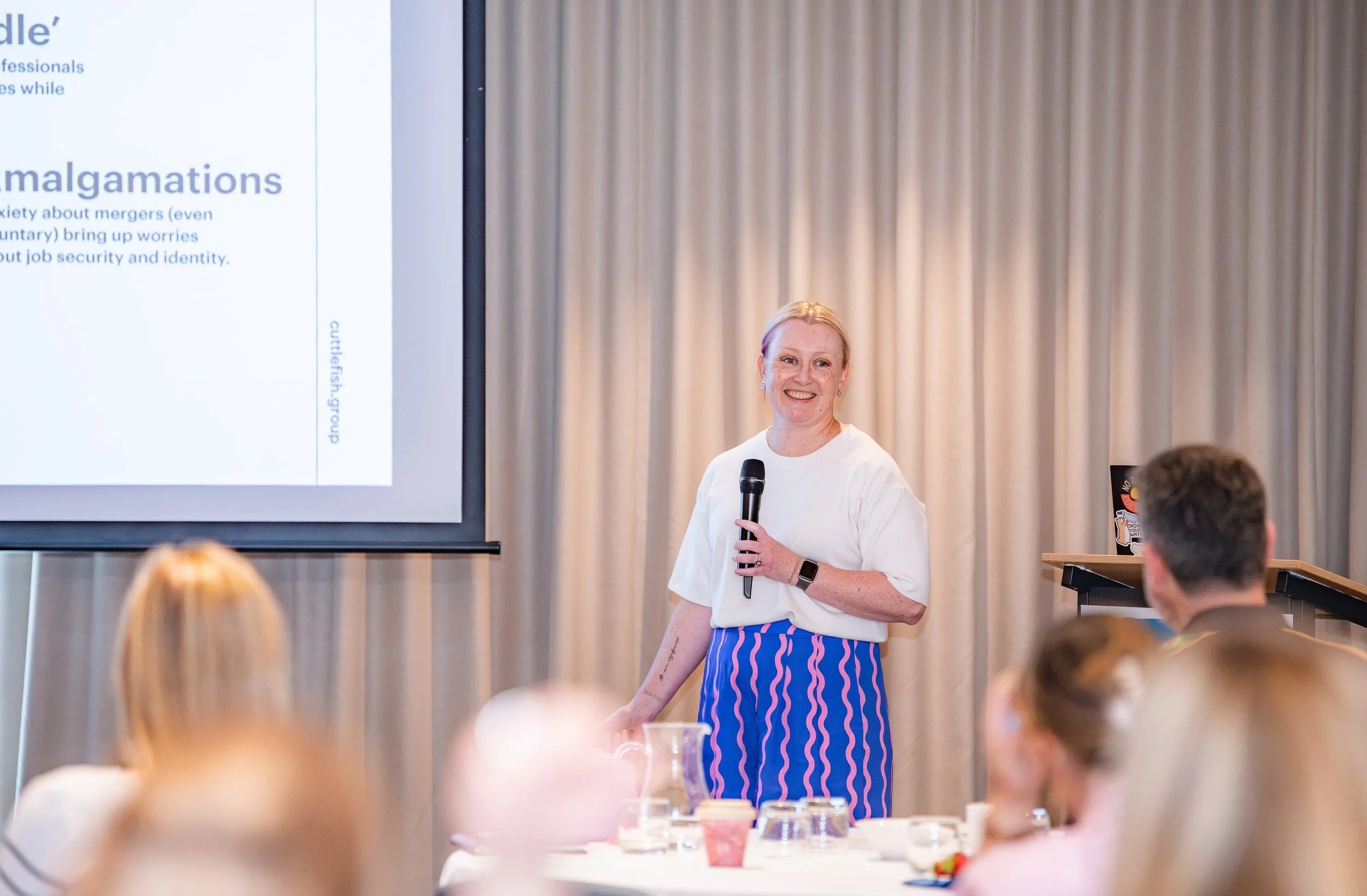 Photo of Mel speaking at a conference