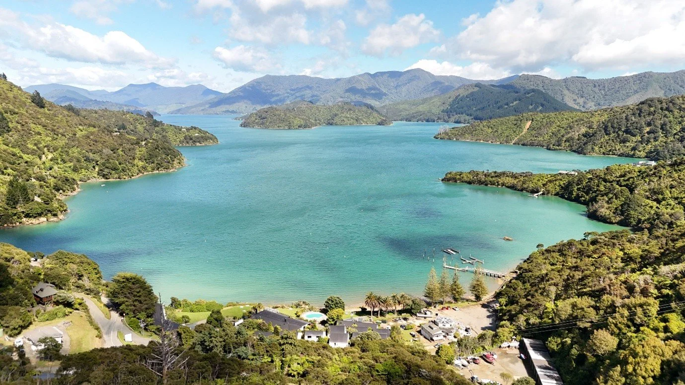 Aerial view of Portage Bay and Portage Resort in Marlborough Sounds, New Zealand.