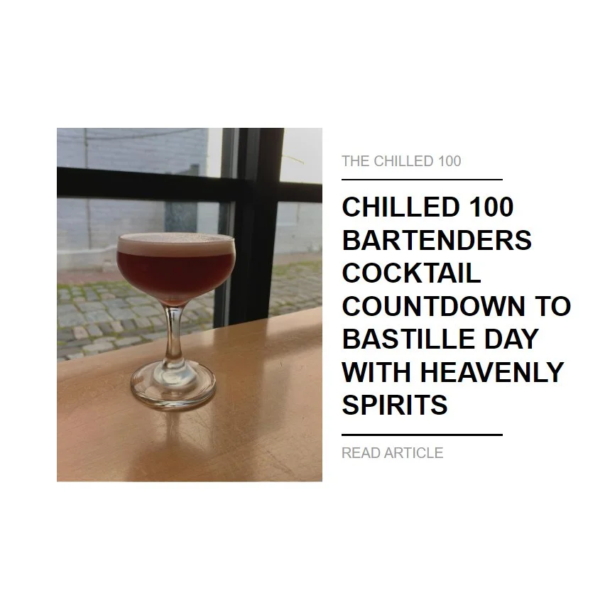 Frothy cocktail on a bar edge in front of a window