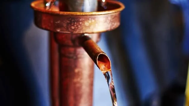 Copper still with eau-de-vie pouring out