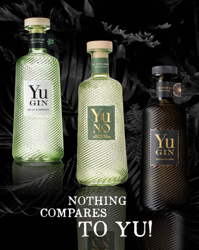 Green textured glass bottles of Yu Gin and Yu No Alcohol Free Spirit with a black textured bottle of Yu Black Gin on a dramatic black background reading "Nothing Compares to Yu."