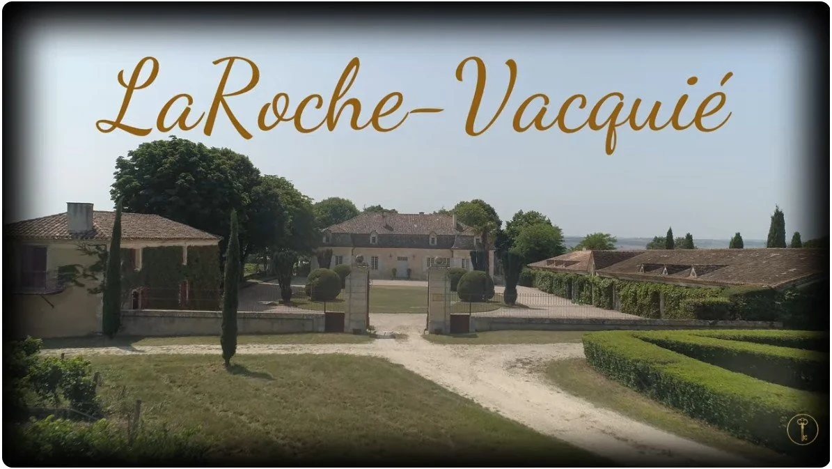 Image of a drive leading towards a French chateau with the words LaRoche-Vacquié in script across a blue sky.
