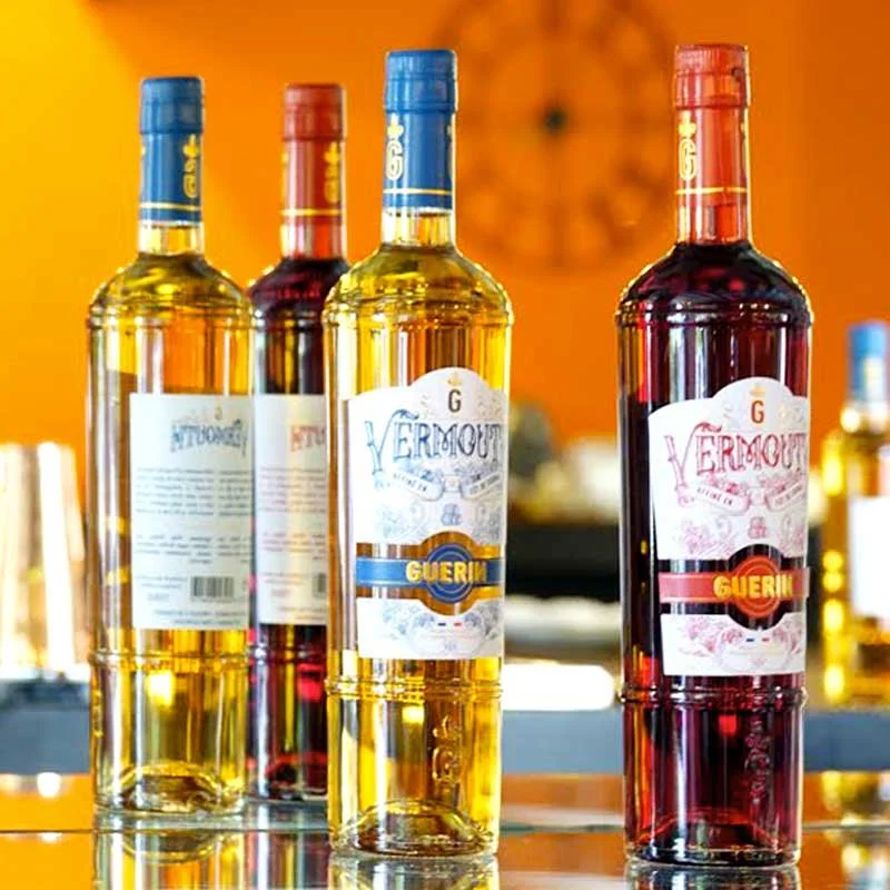 Four Vermouth bottles on a yellow orange background