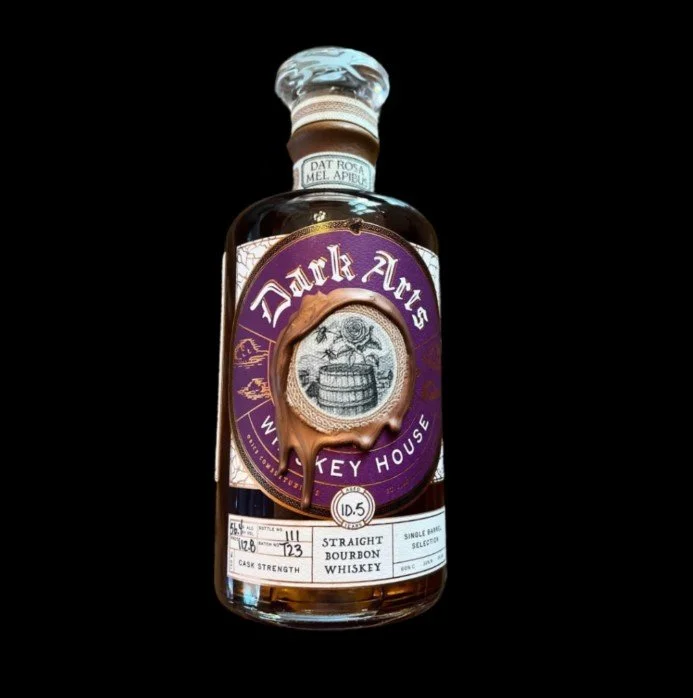 Purple labeled Dark Arts bottle on a black background