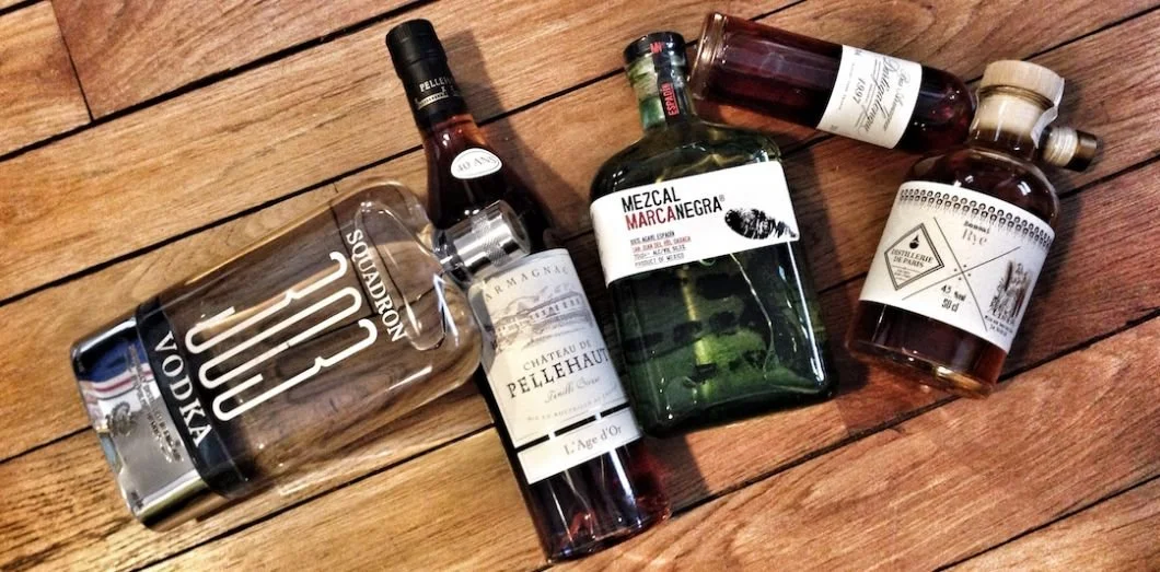 5 liquor bottles on a wood floor