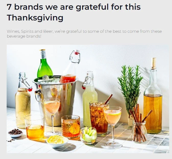 Cocktail-making setup with ice bucket, bottles, garnishes, and glassses