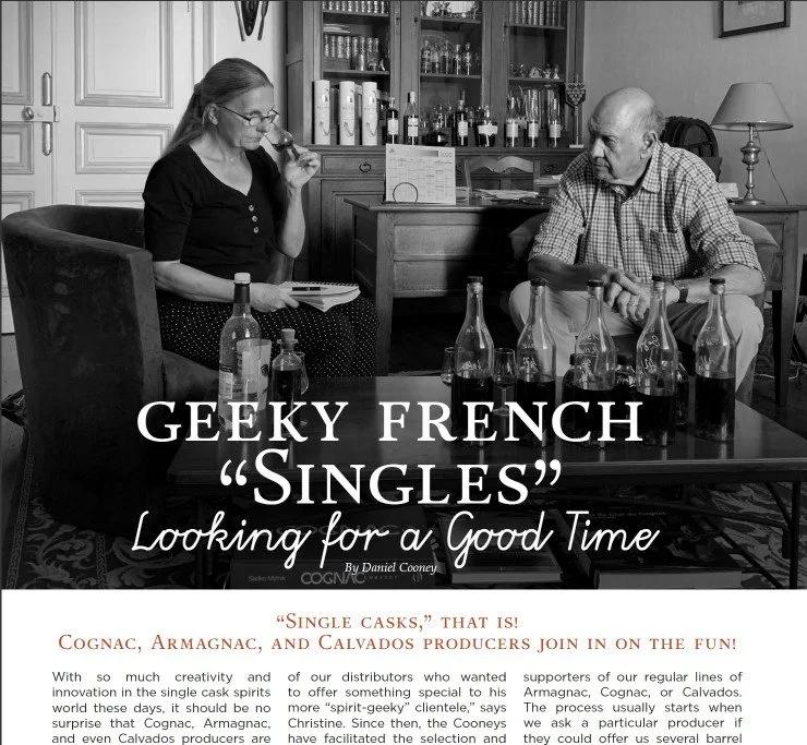 Black and white photo of man and woman sitting in a library and tasting cognac samples