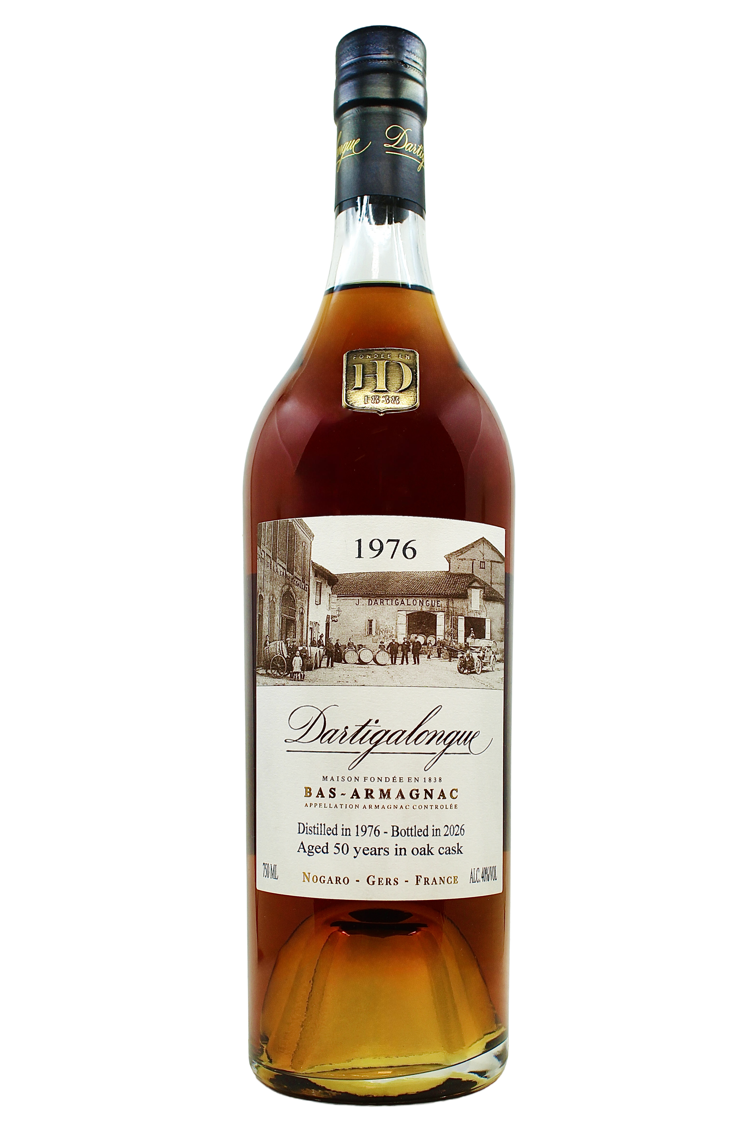 Close up on Dartigalongue Bas Armagnac 1976 vintage with an antique photo of the distillery's forecourt and gold seal on the neck. 