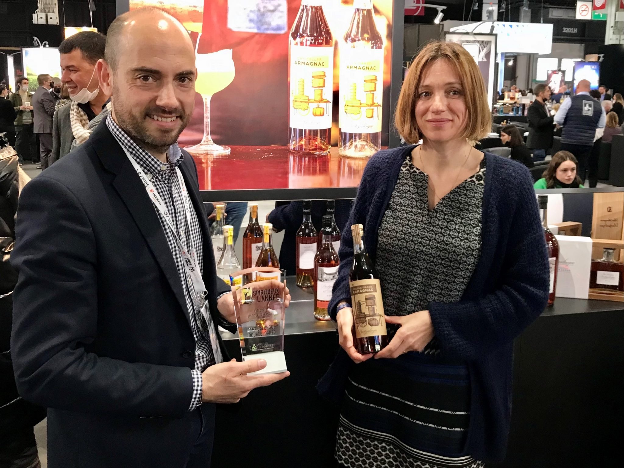 Man and woman hold accepting an award for Armagnac
