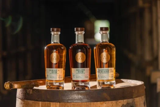 Three whisky bottles on a barrel top