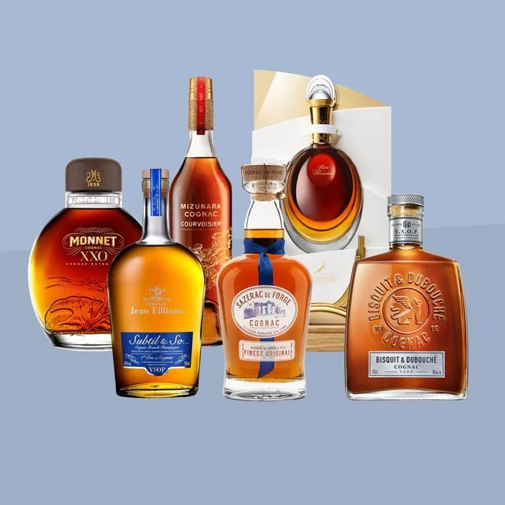 Collection of 6 cognac decanters on a grey background
