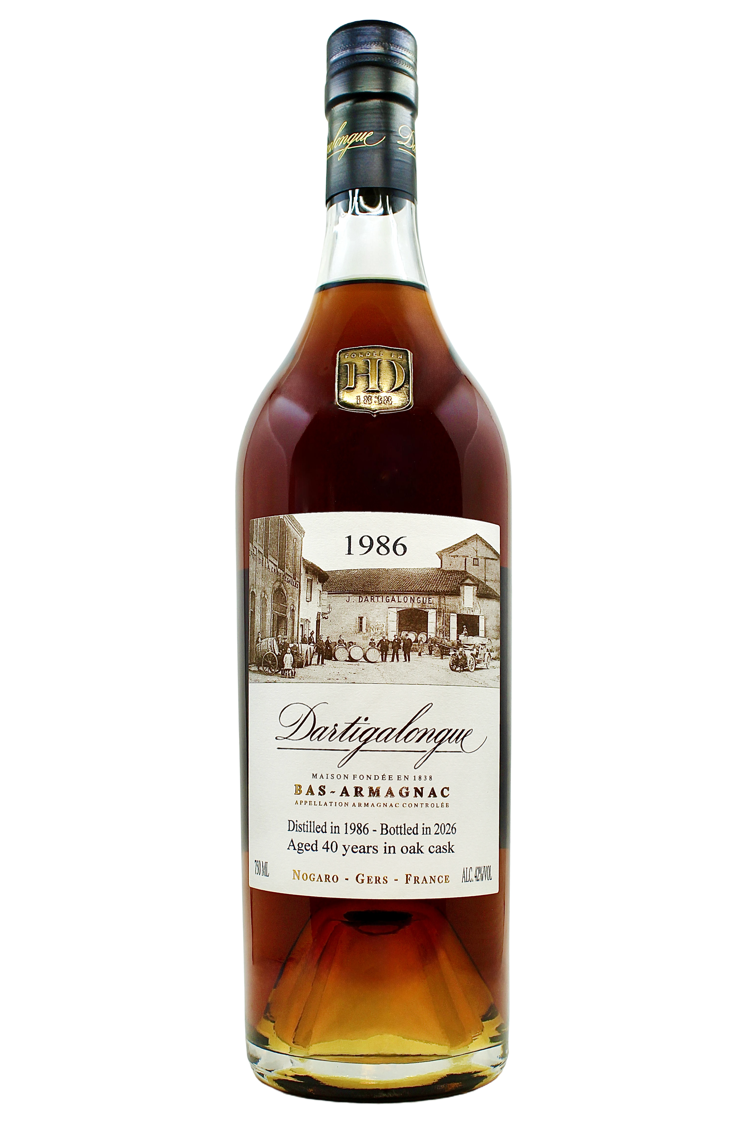 Close up on Dartigalongue Bas Armagnac 1986 vintage with an antique photo of the distillery's forecourt and gold seal on the neck. 