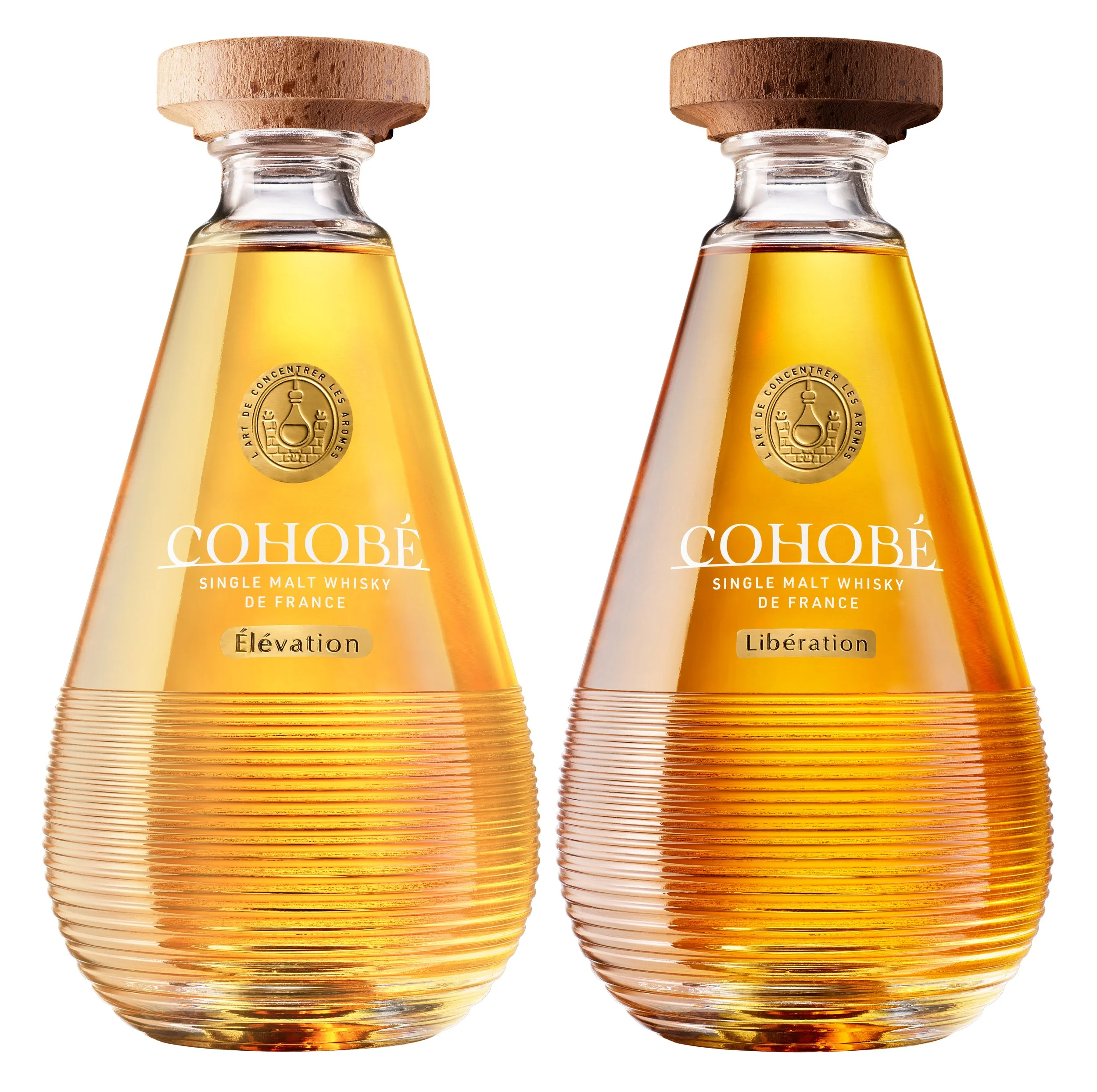 Two ribbed tear drop shaped whisky bottles with wide wooden stoppers