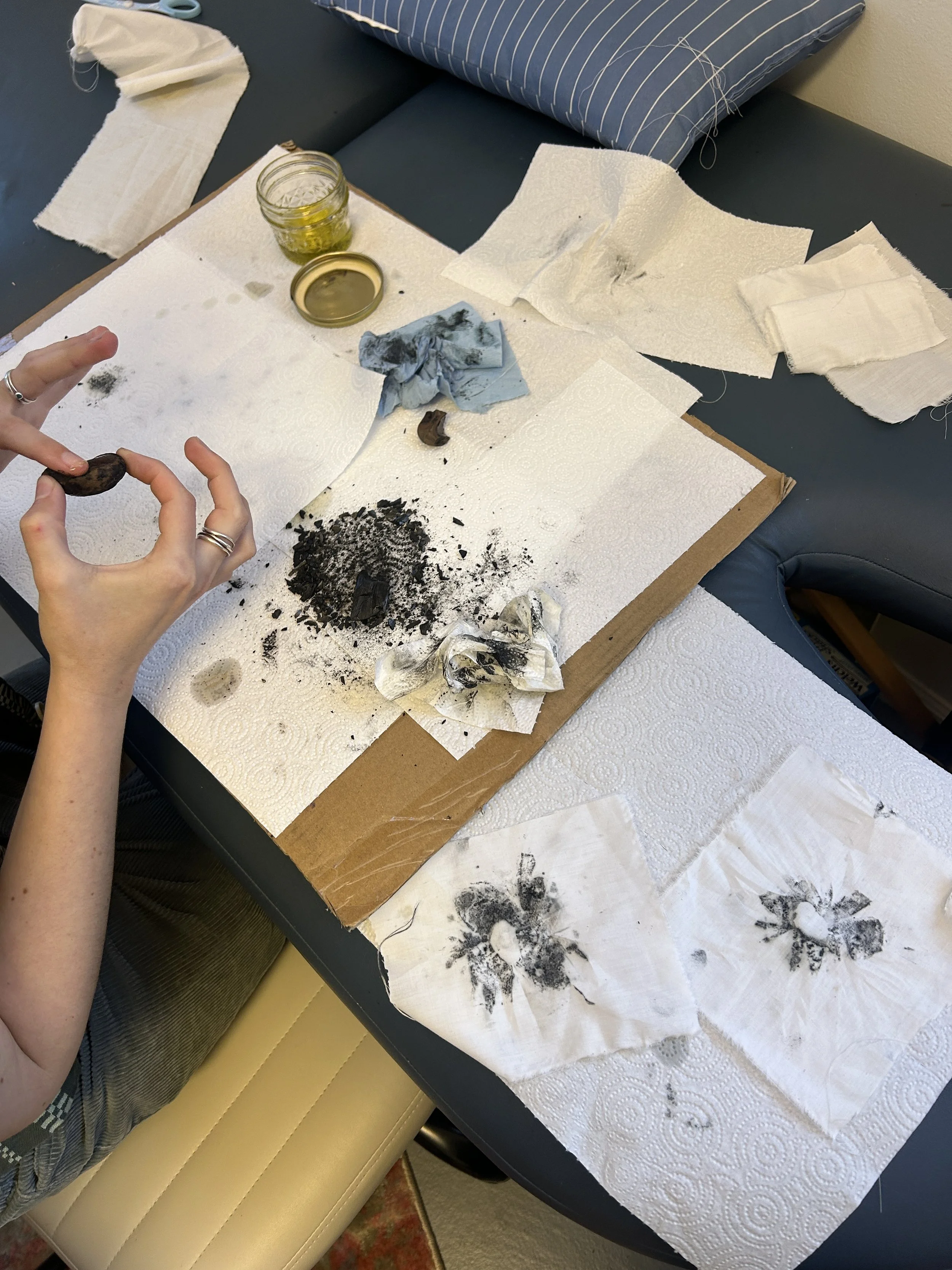the printing process - using a crude ink made with driftwood charcoal & oil, and printed onto fabric