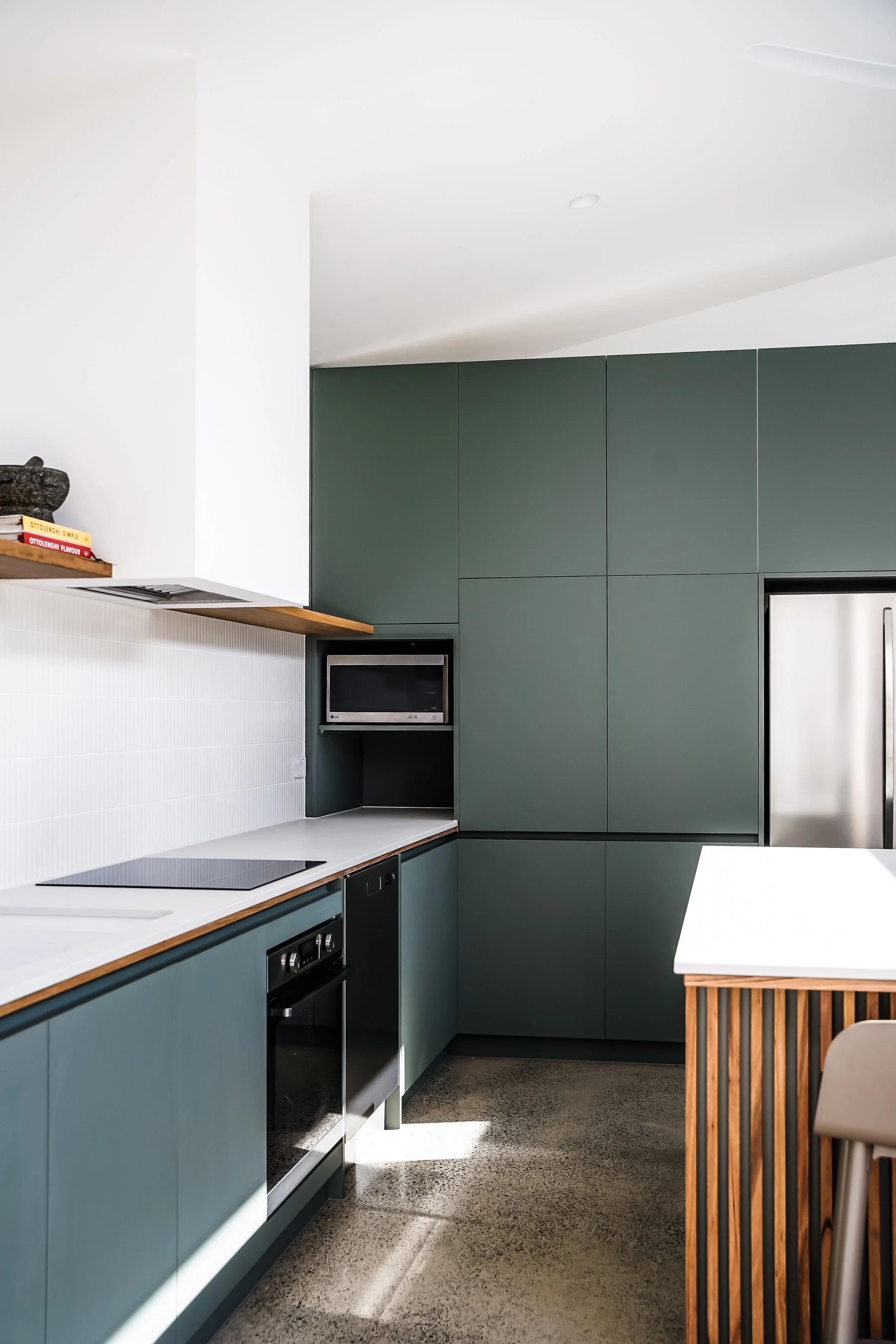 quality kitchen and appliances, white wall, green cabinets, black appliances