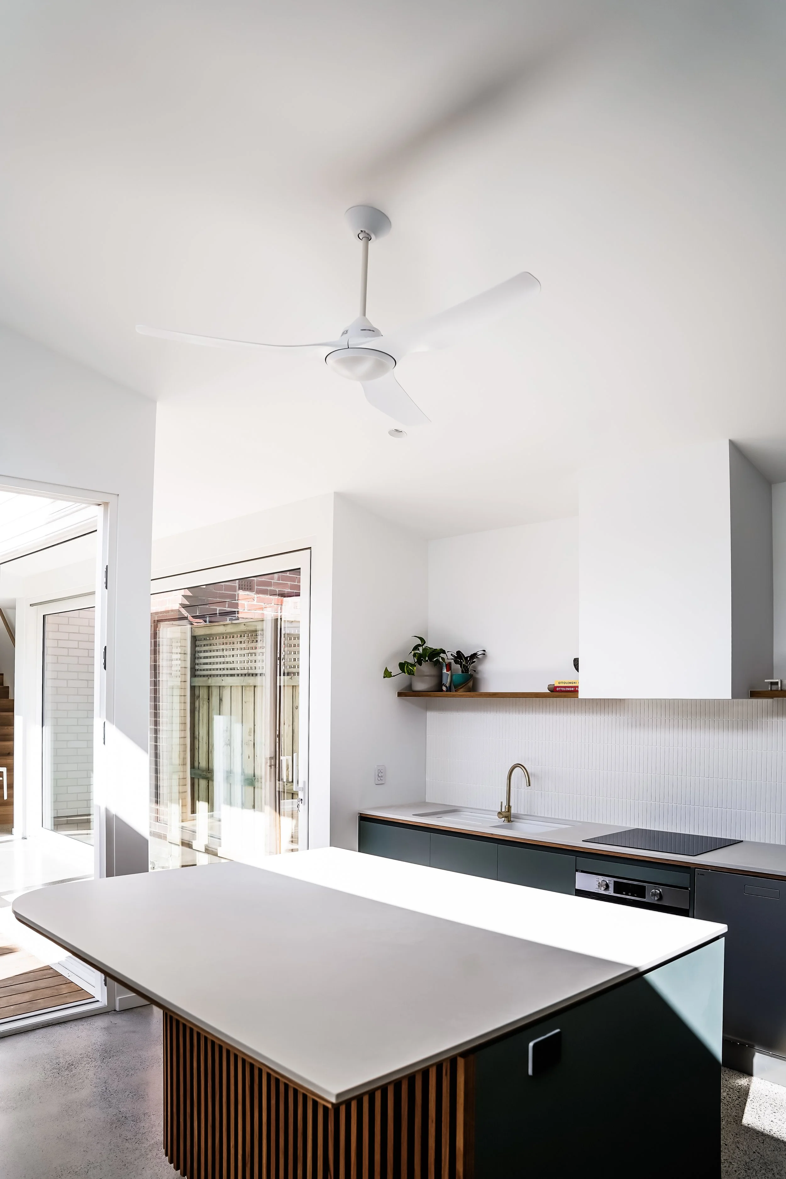 kitchen renovation white theme. white walls and ceiling, white ceiling fan