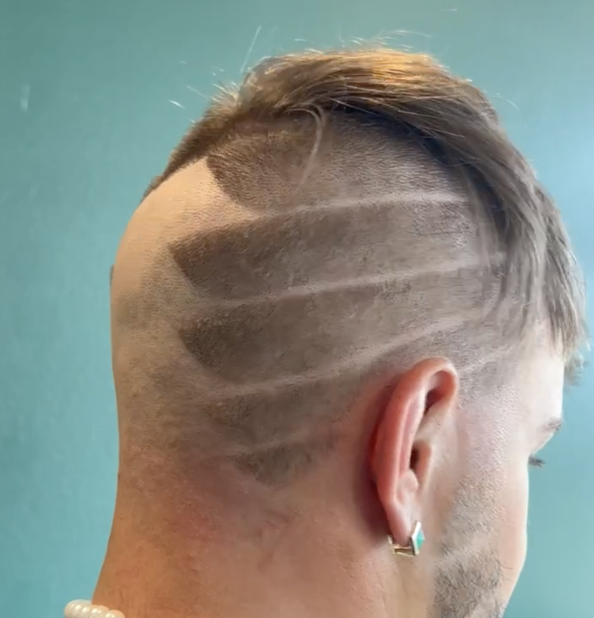 Modern men’s haircut with razor line design at Bend Oregon barbershop