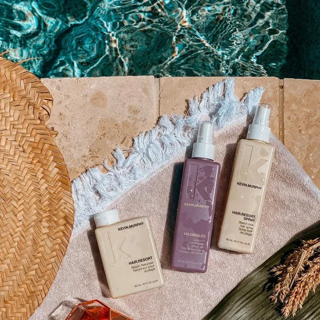 Kevin Murphy hair care product lineup, including bottles and packaging of various hair treatments and styling products.
