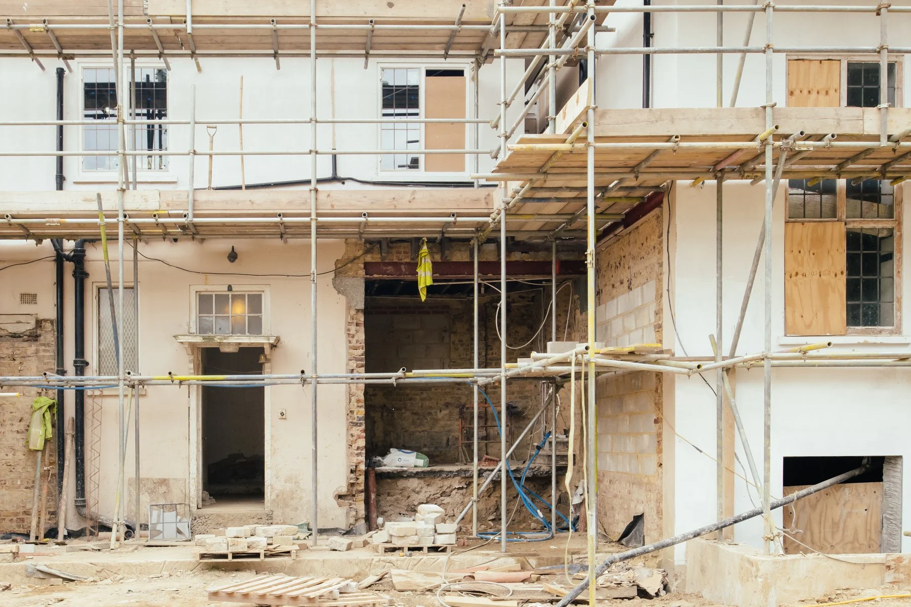 A listed Building under construction with scaffolding and partially finished walls.