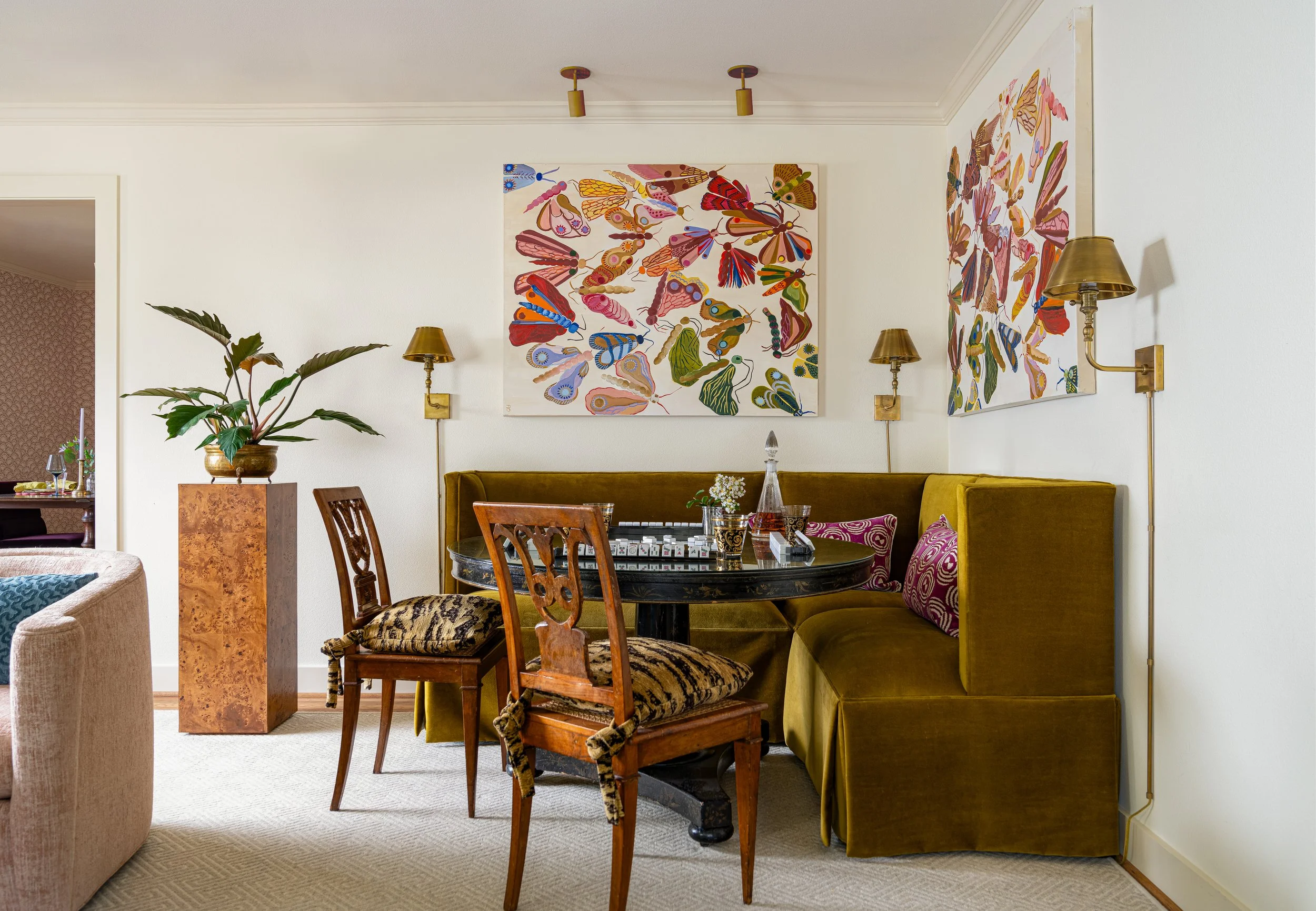 Colorful dining nook captured by an interior design photographer in Texas, featuring velvet seating, eclectic artwork, and bold textures - an elevated example of interior design photography in action.