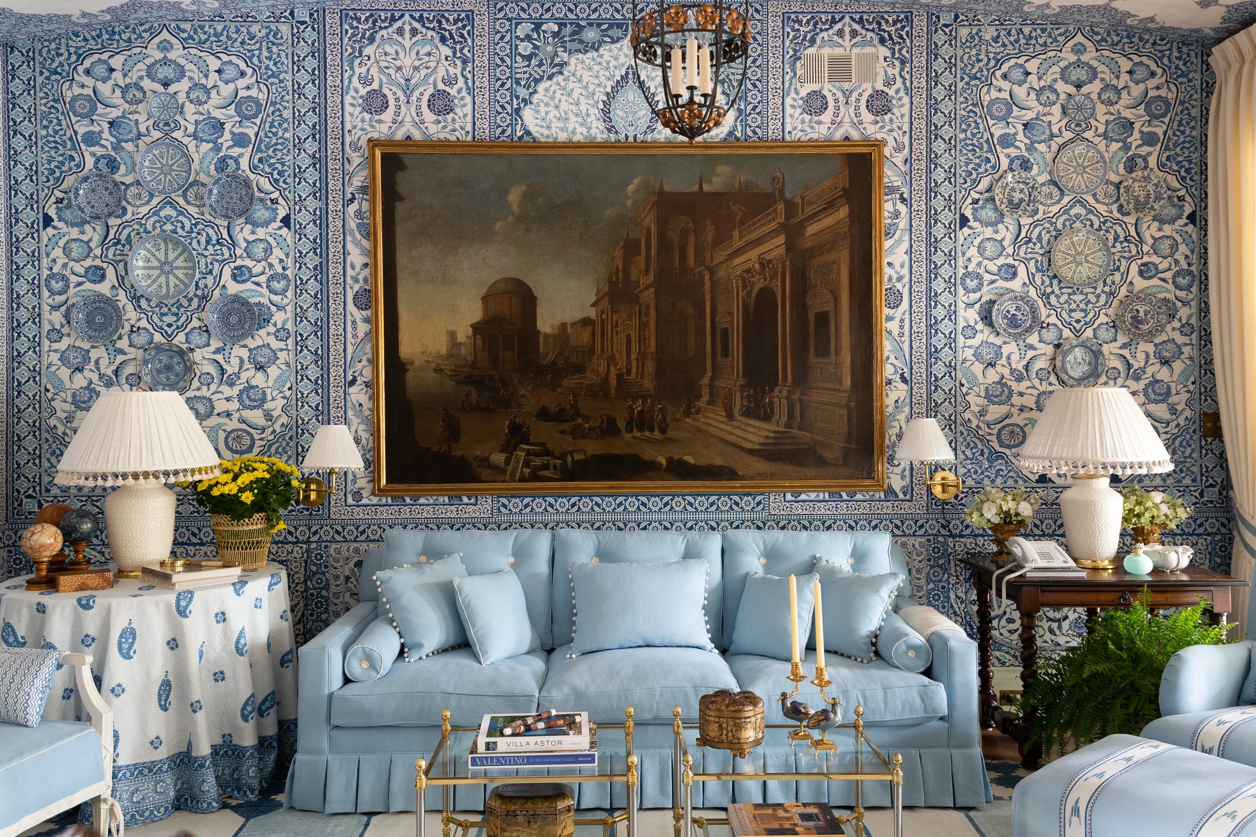 Interior design photography by Texas-based photographer Jeff Jones. Elegant blue living room with ornate wallpaper, classic artwork, vintage furniture, and gold accents, rich in traditional style.