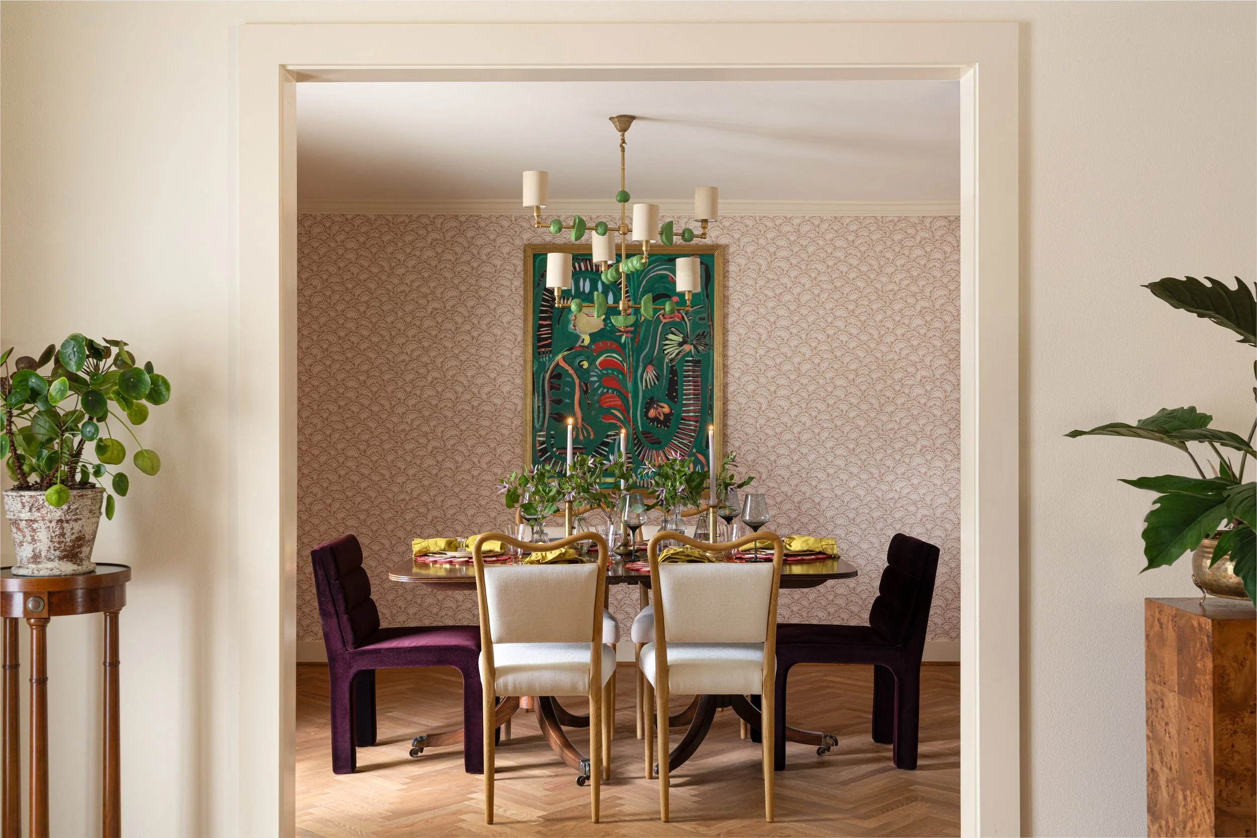 Vibrant dining room with velvet chairs, bold artwork, and mid-century accents. Interior design photographer in Texas showcasing dynamic and curated interior design photography.