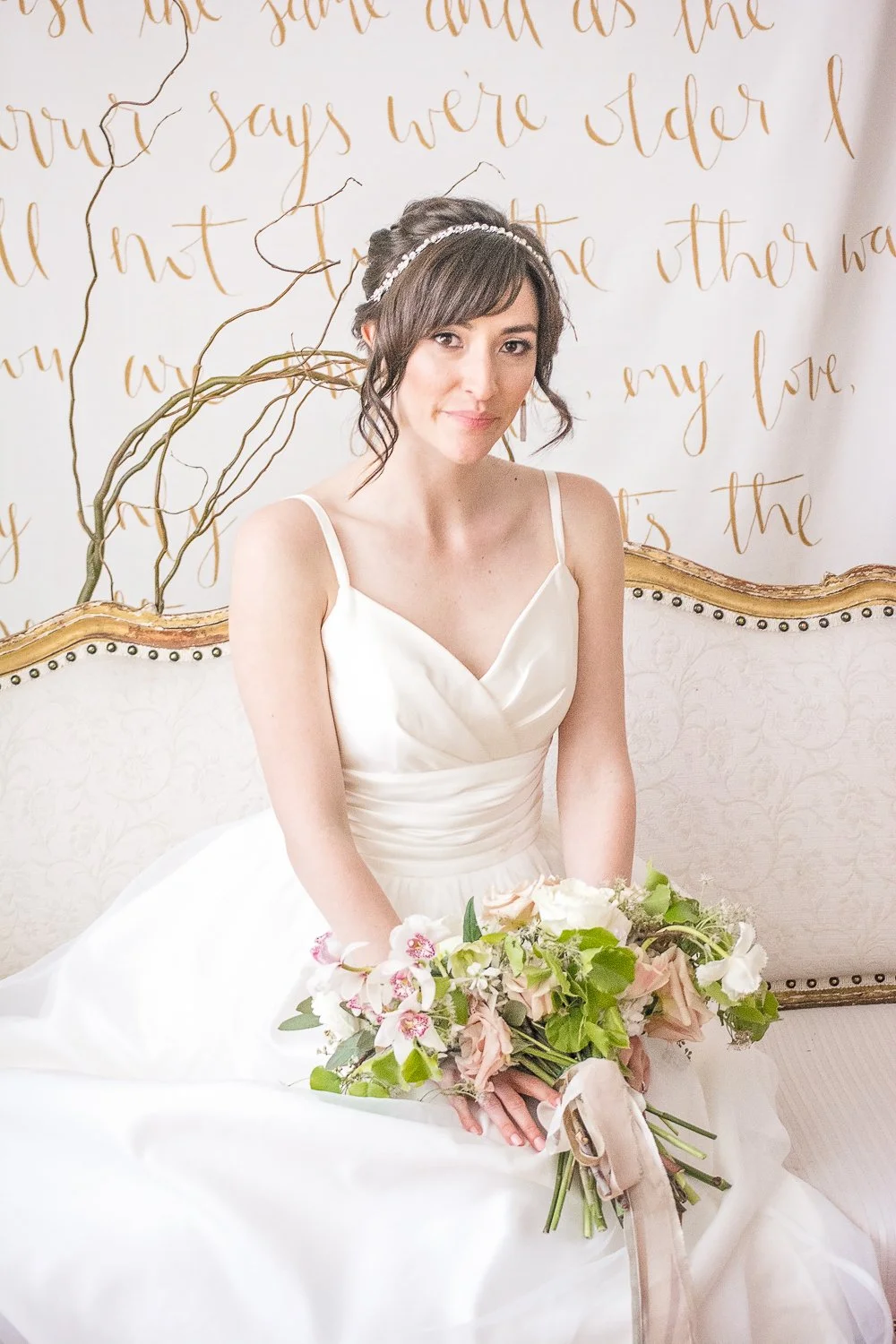 Bride sits on couch during Bernalillo styled photo shoot