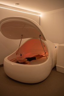 A woman floating in a float pod at Soul Float. Filled with 500 kgs of Epsom salt, floating is effortless.