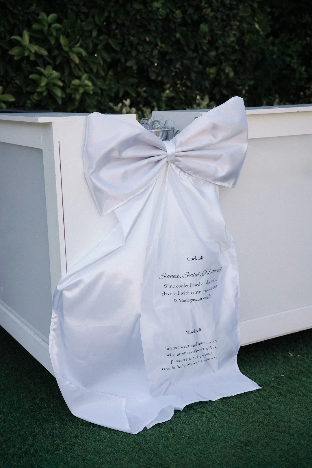 white bow with serves as a menu for cocktails