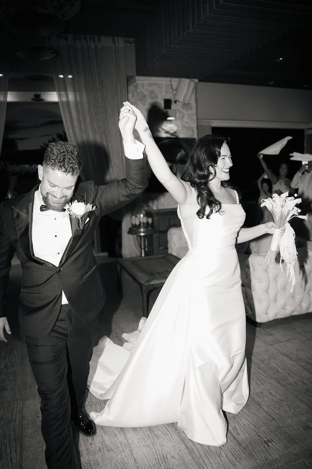 bride and groom enter the wedding reception