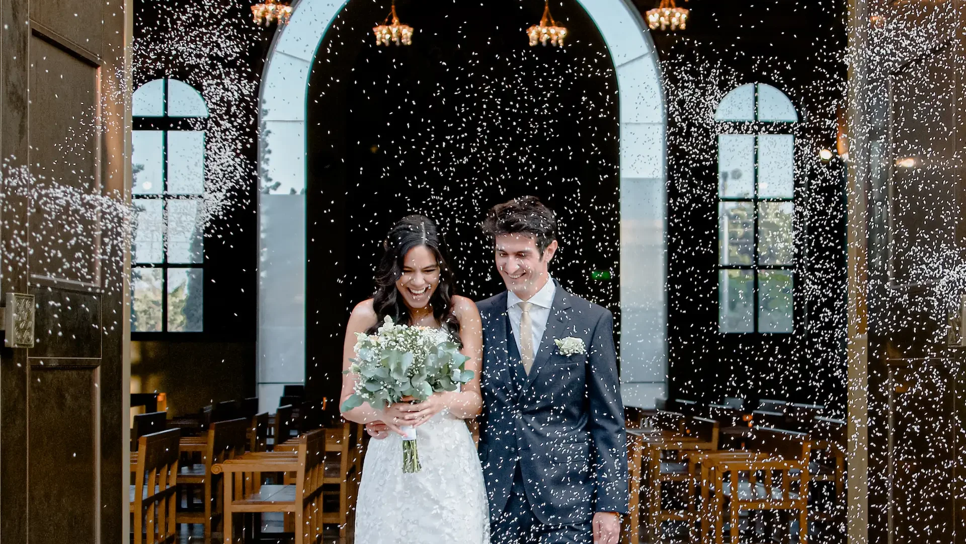 newly married couple in greece gets sprayed with rice