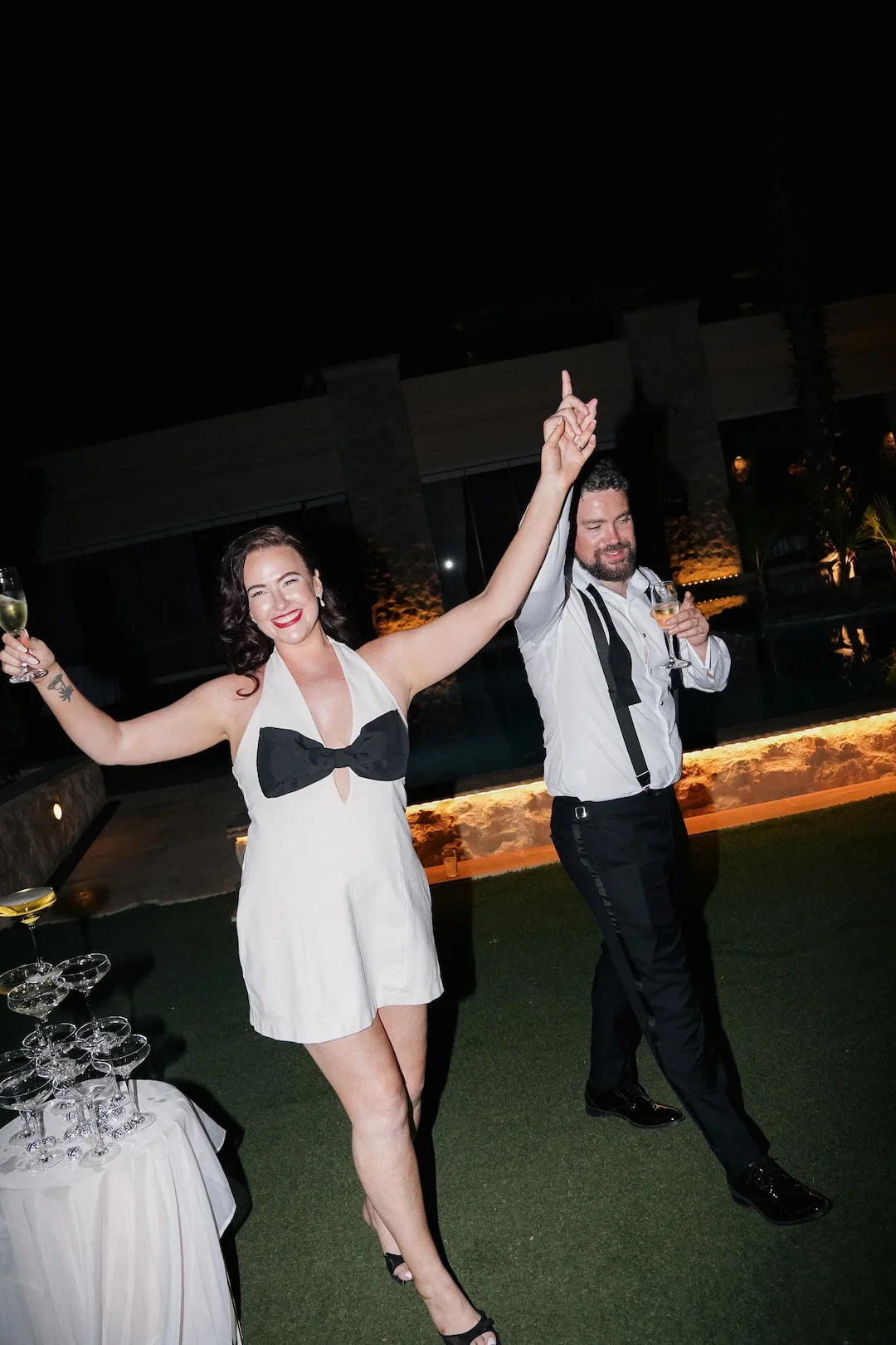 bride and groom drinking champagne