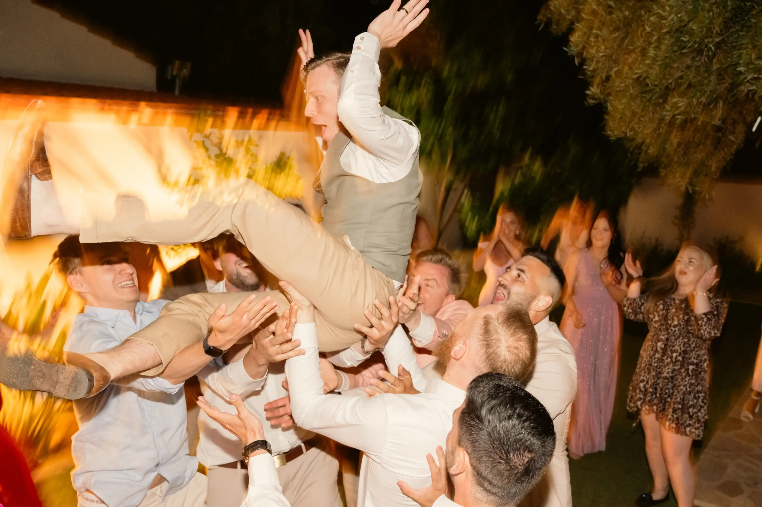 a-groom-being-tossed-in-the-air-at-his-wedding.webp