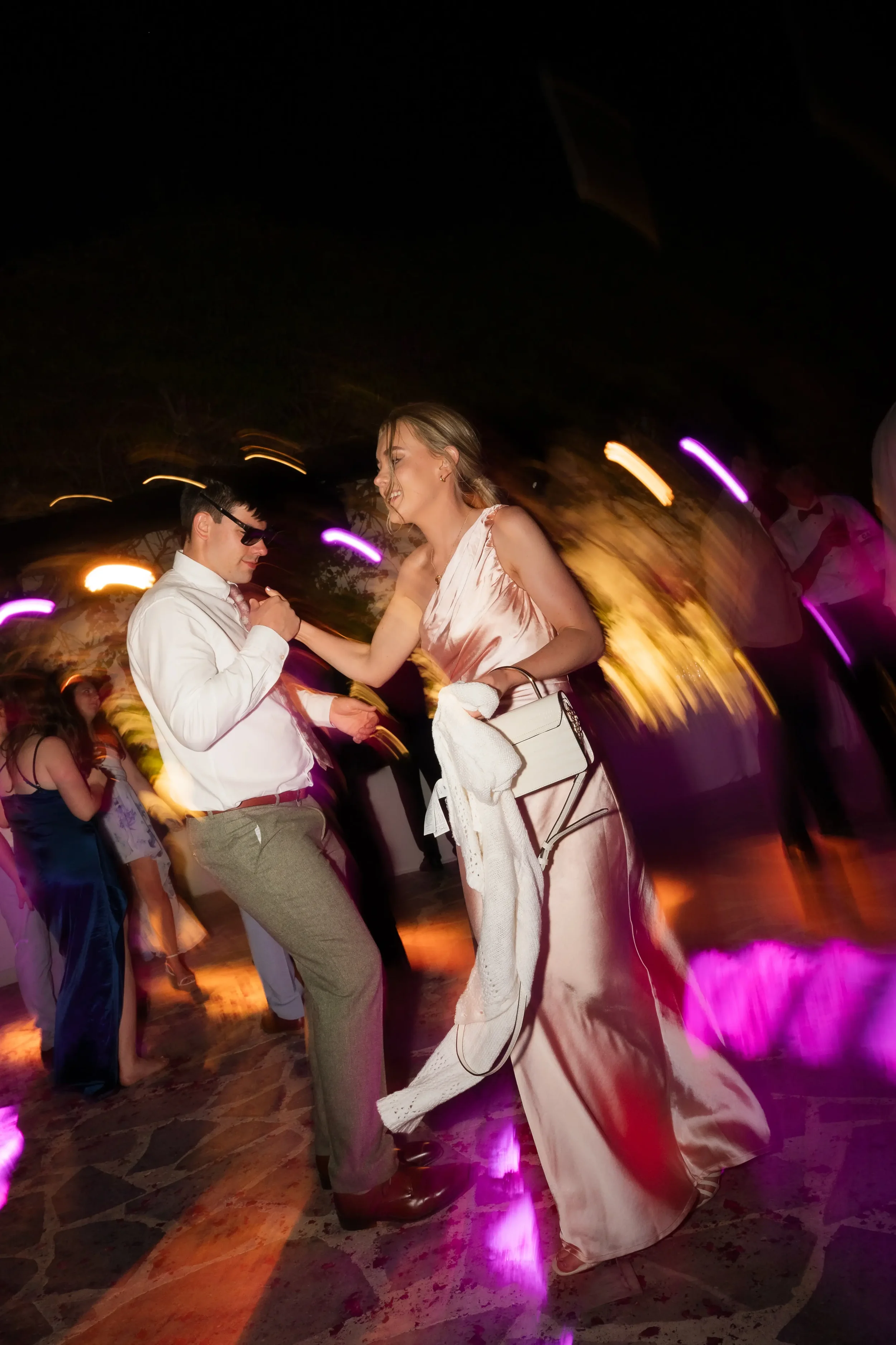 bridesmaid-dancing-at-a-destination-wedding-in-greece.webp