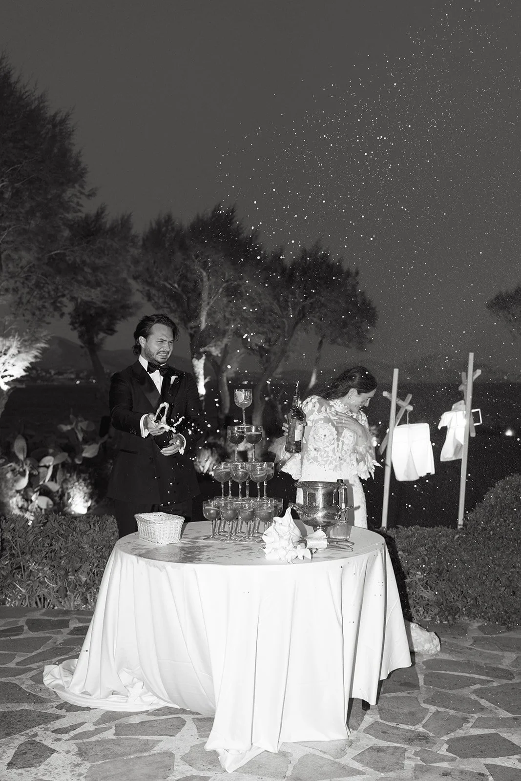 married couple popping a bottle of champagne