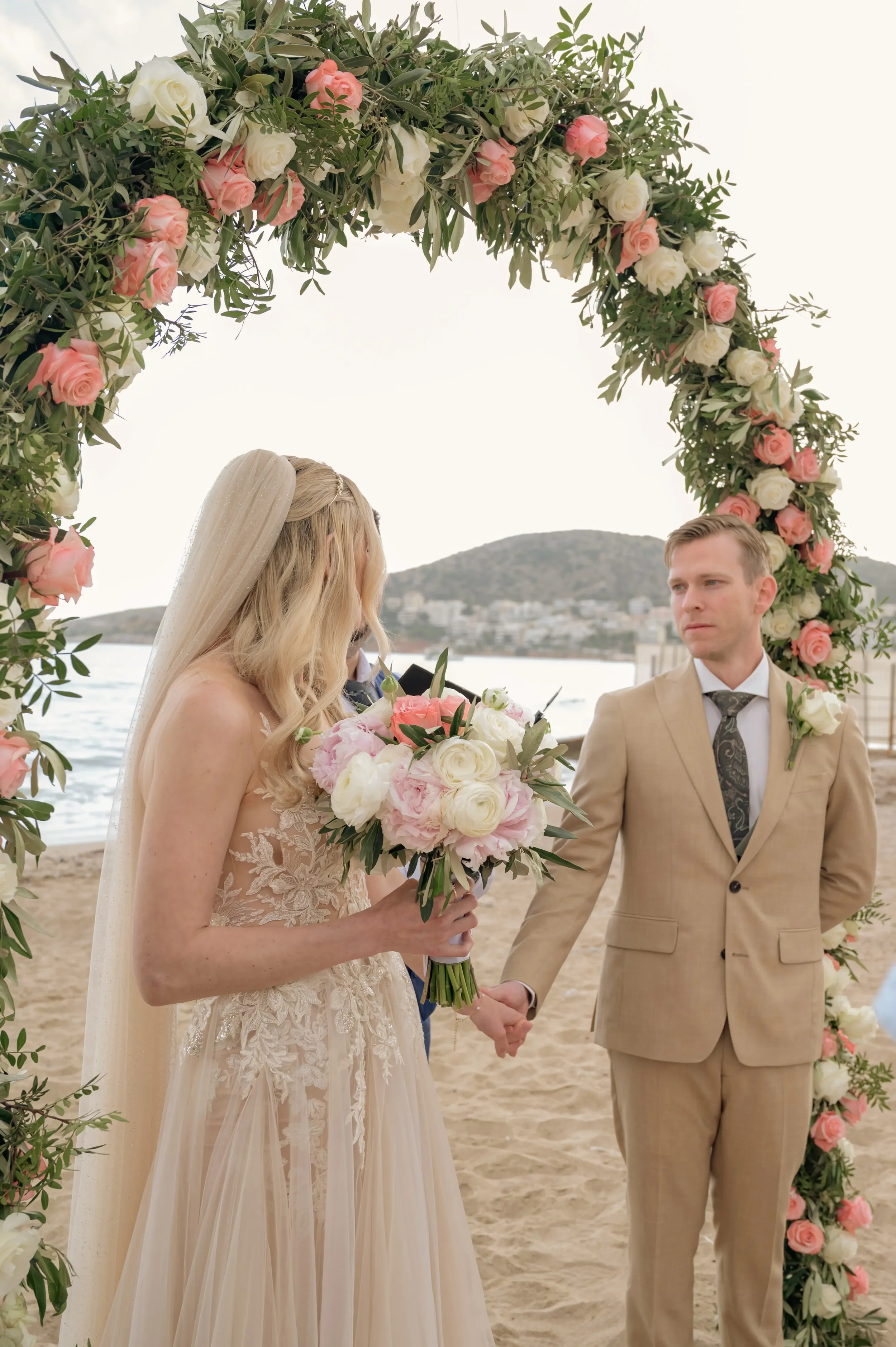 bride-and-groom-under-a-flower-arch.webp
