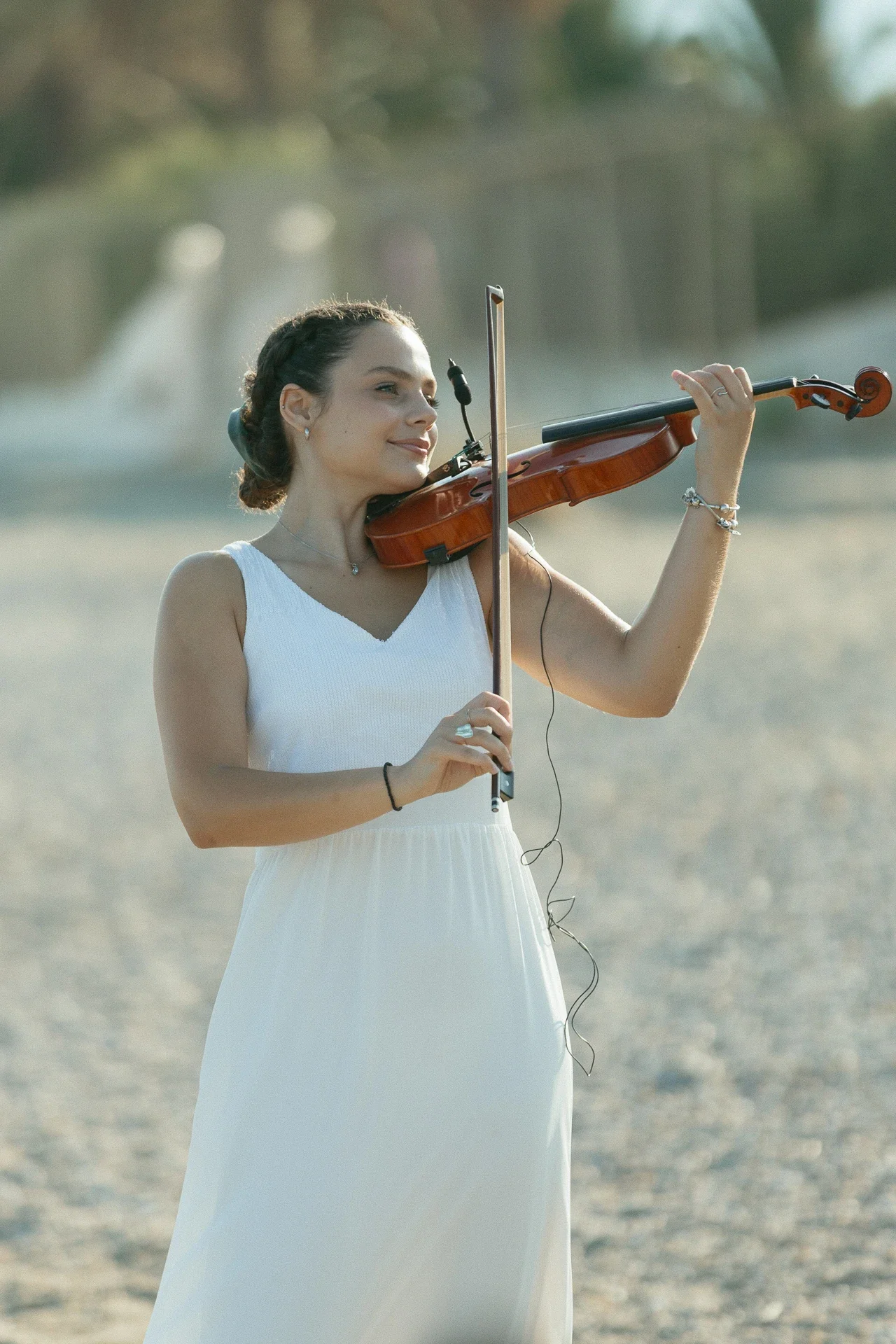 violin-player-performing-by-the-sea-for-a-destination-greek-wedding.webp