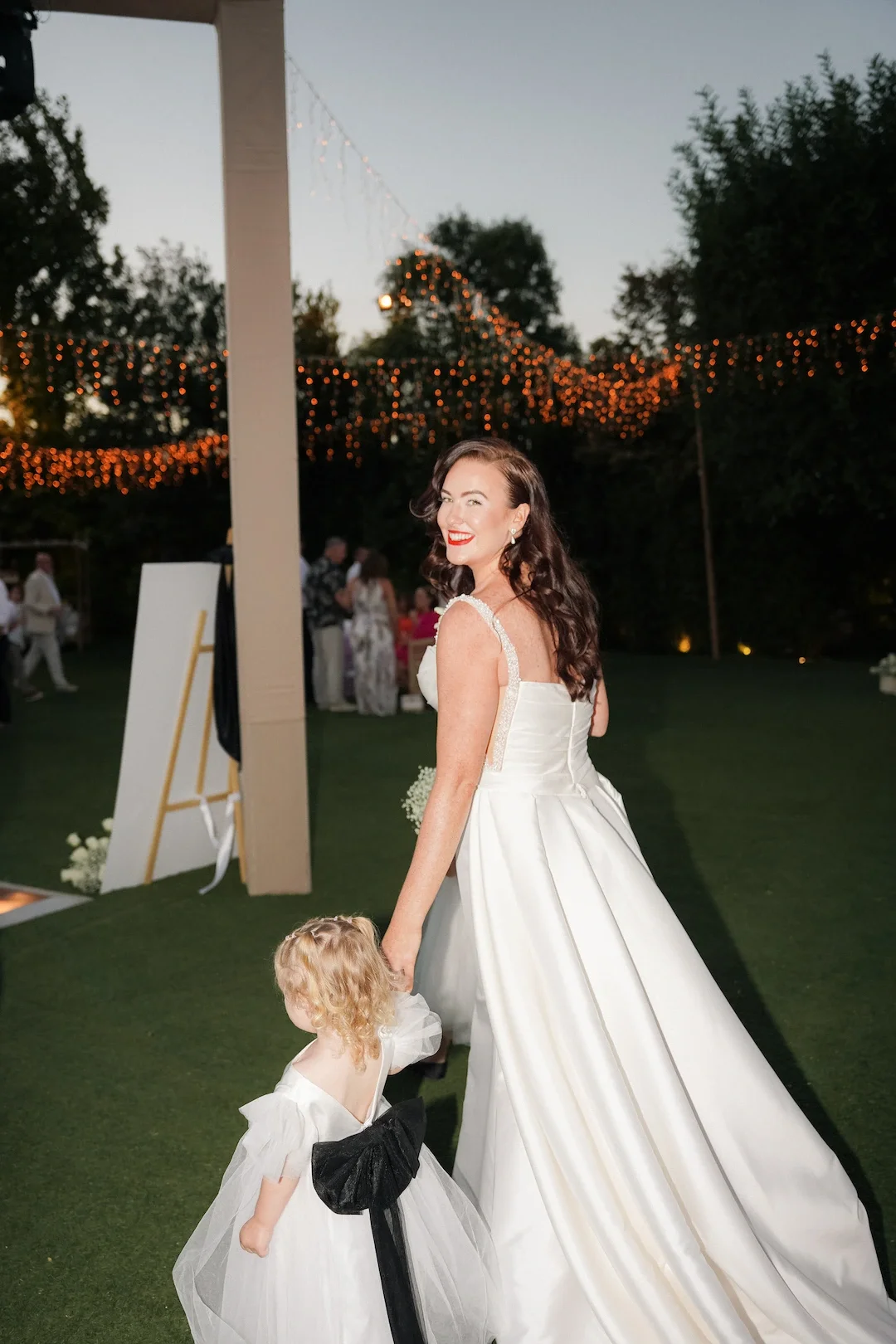 bride and flower girl walking at the wedding reception
