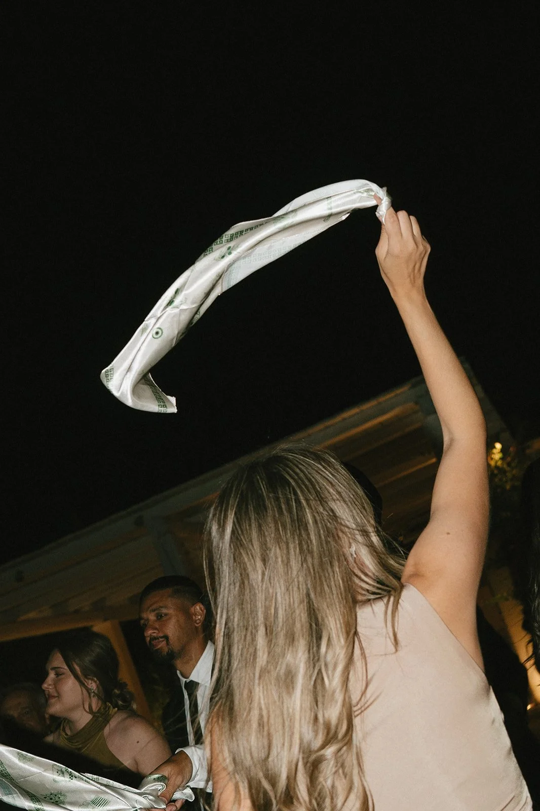 guest waving a scarf at a wedding