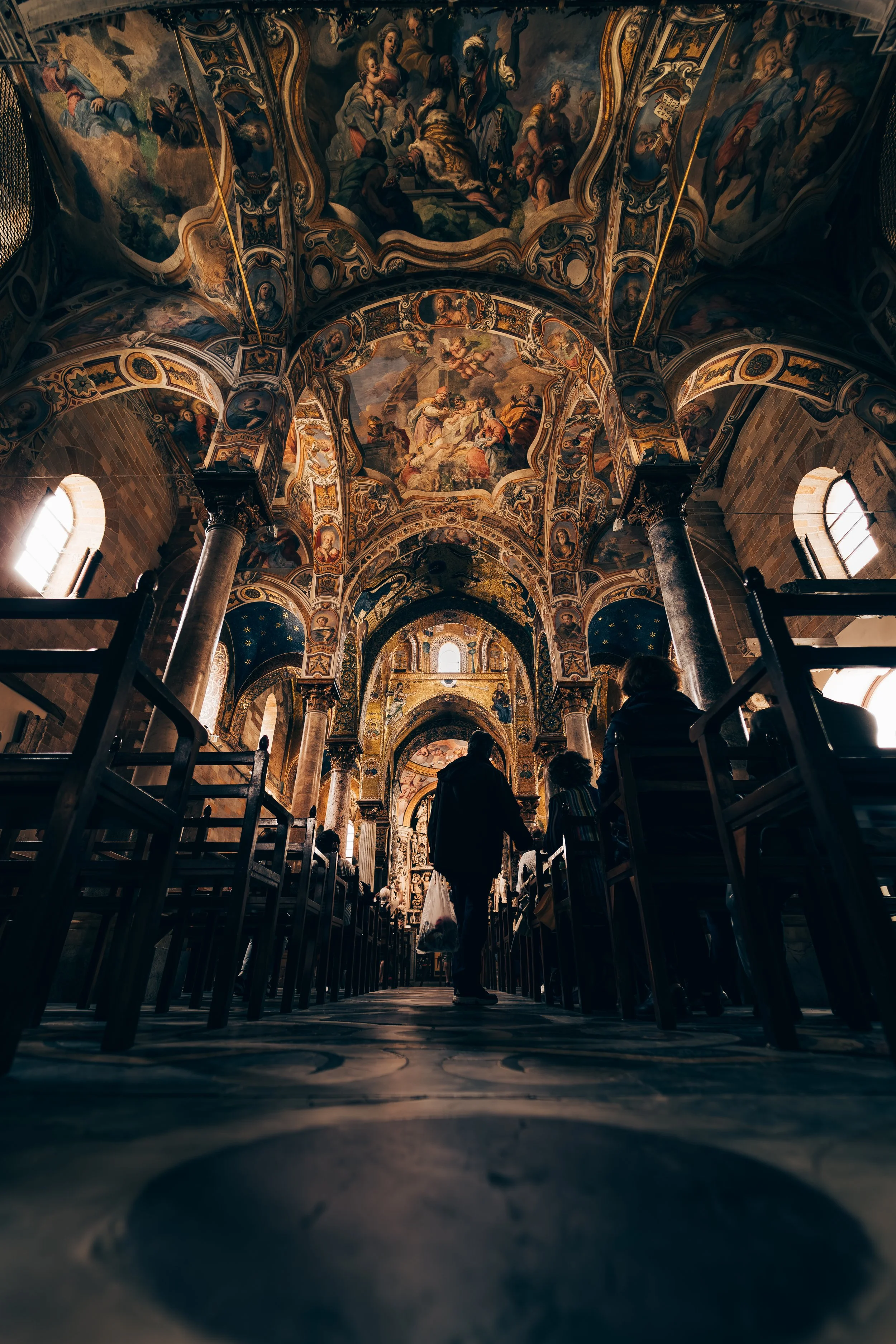 Ornate church interior with painted ceilings and arched columns