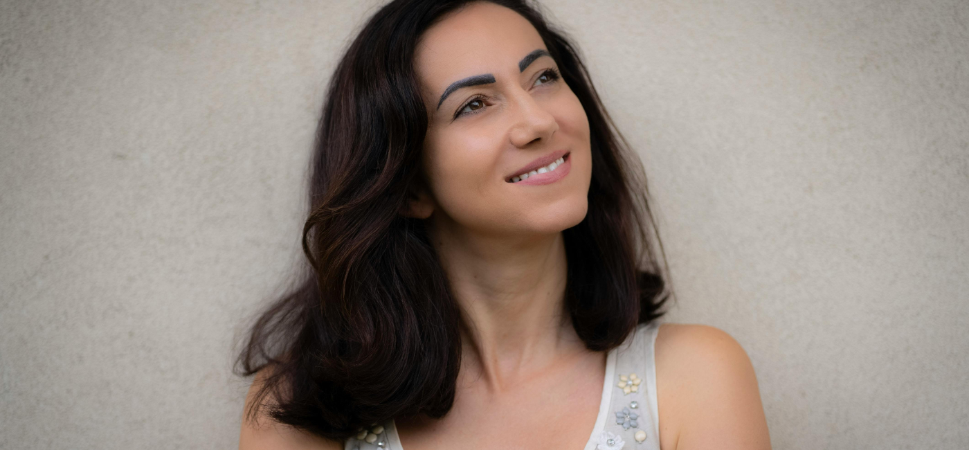 Woman with soft upward gaze — somatic practitioner training for women