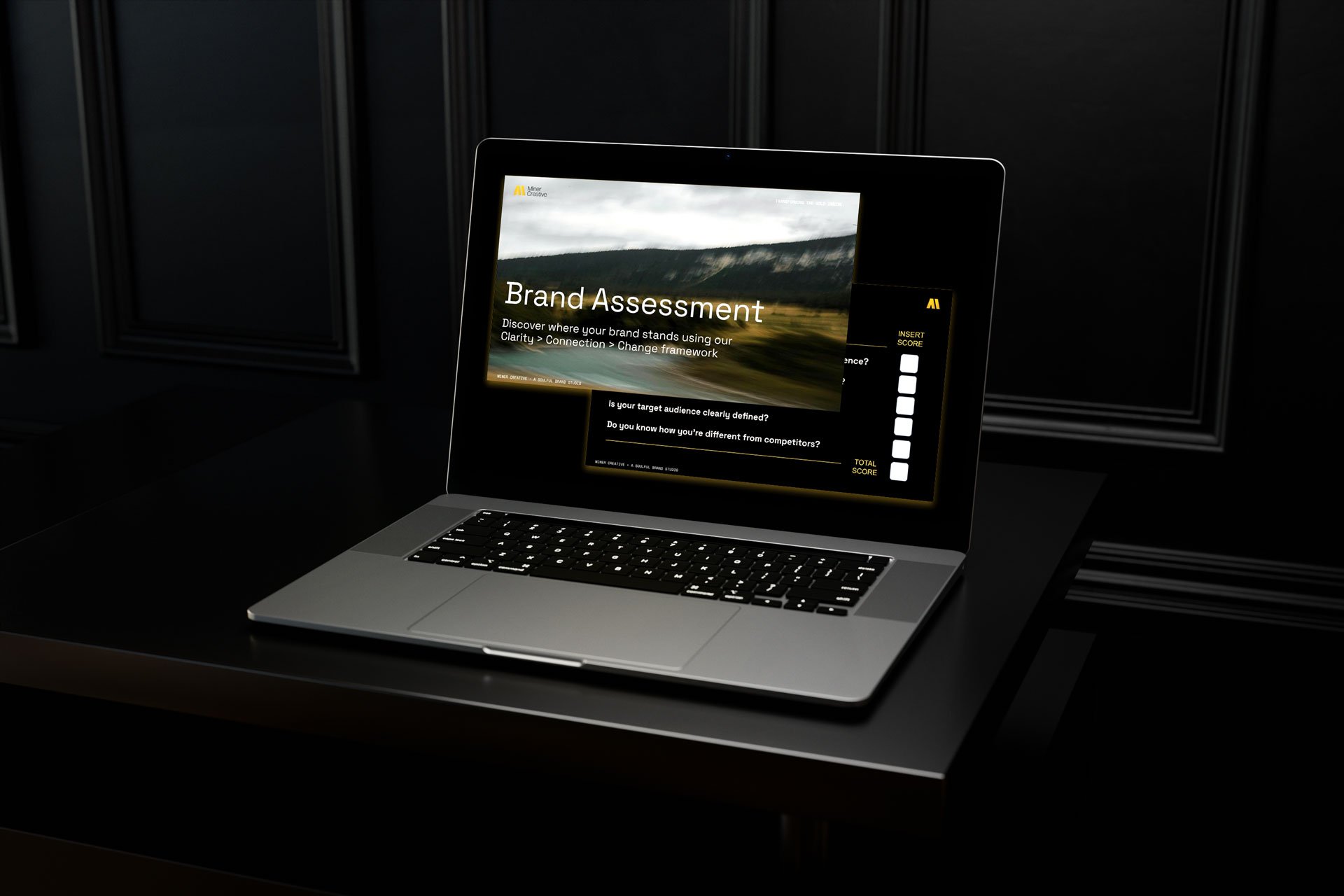 Laptop on dark desk displaying a presentation slide titled 'Brand Assessment', with a scenic outdoor background and additional text about brand clarity and connection.