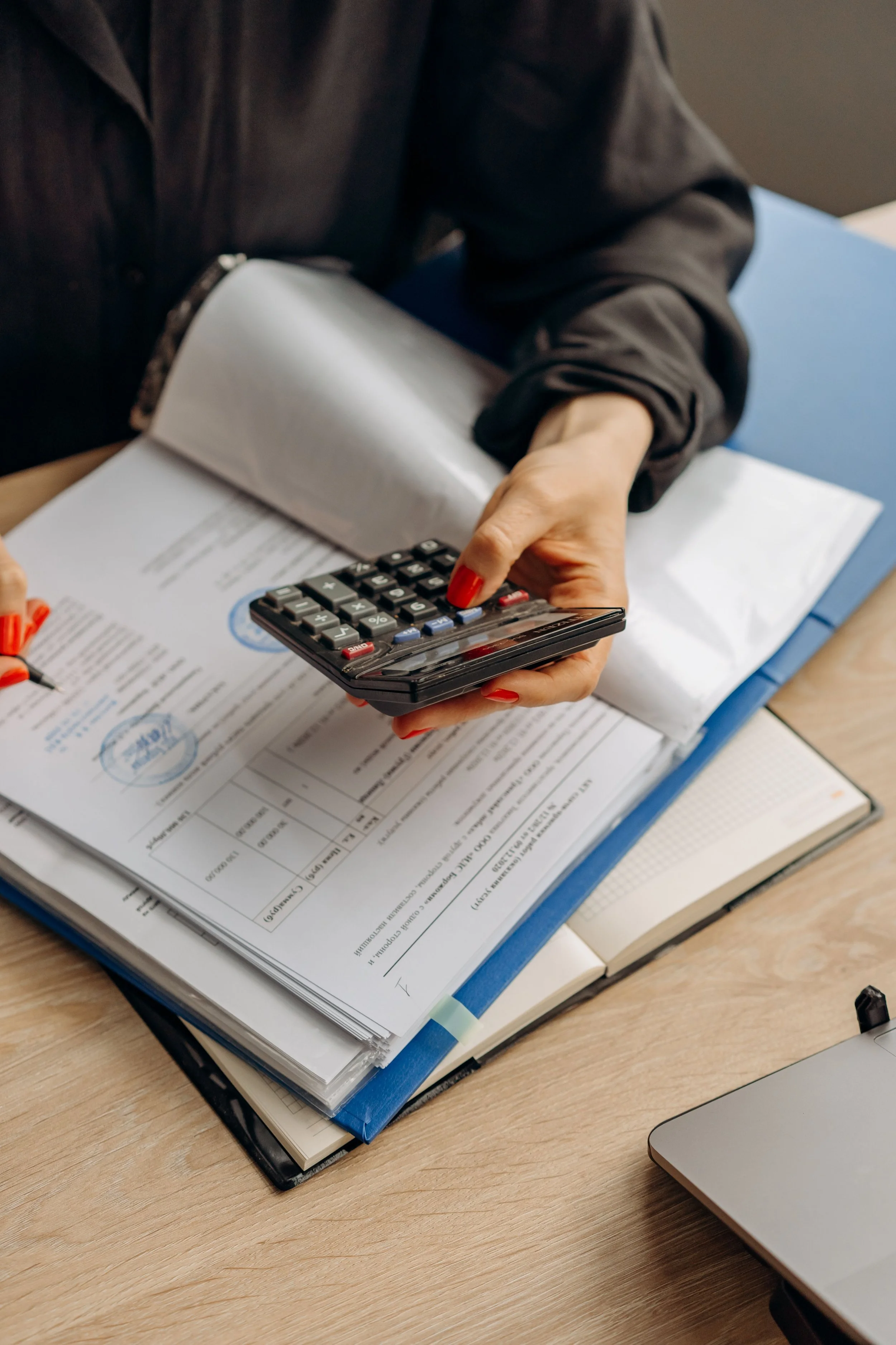 Property management professionals reviewing financial documents and administrative plans for a high-rise community association.