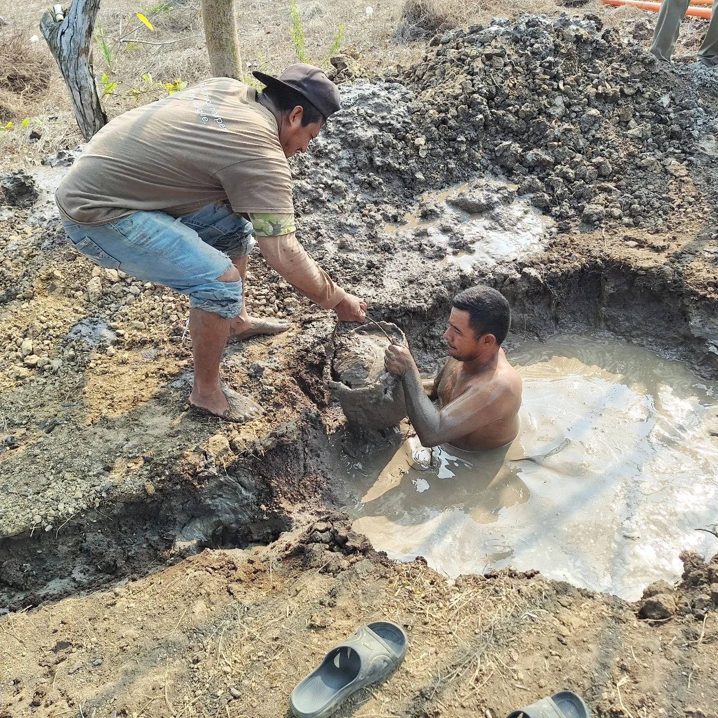 At a recent well drilling trip. One of the local men cleaning the mud pits and getting a skin mud treatment at the same time :-)