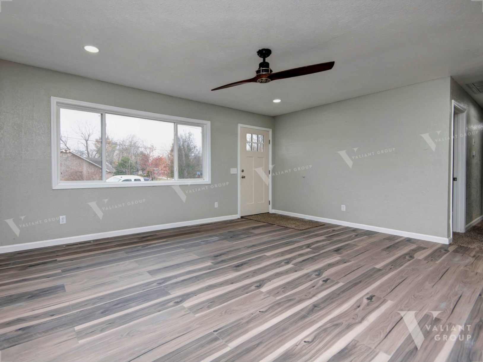 02-304-S-Rice-St-Nixa-living-room-picture-windows-ceiling-fan.jpg