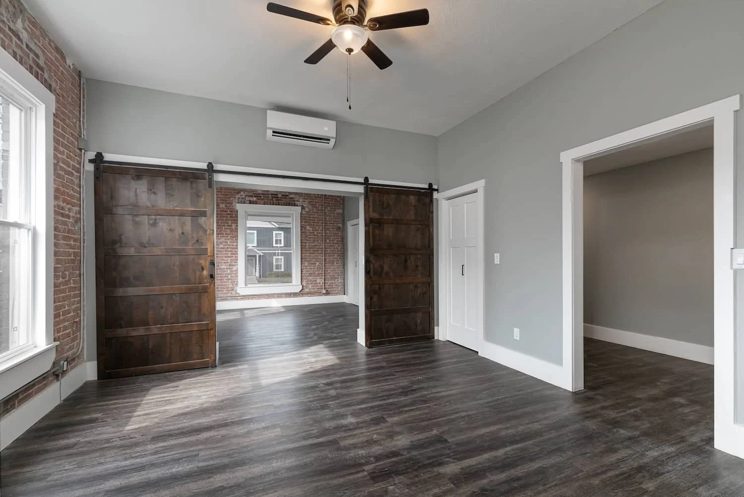 downtown loft apartment for rent in springfield mo apartment 3 living room wood sliding barn doors.jpg