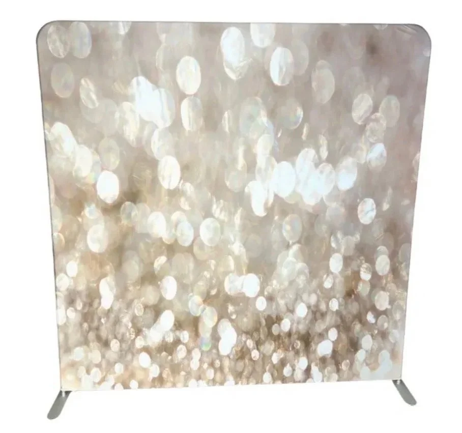 A decorative panel with a bokeh pattern of shimmering, out-of-focus light circles in silver and white tones.