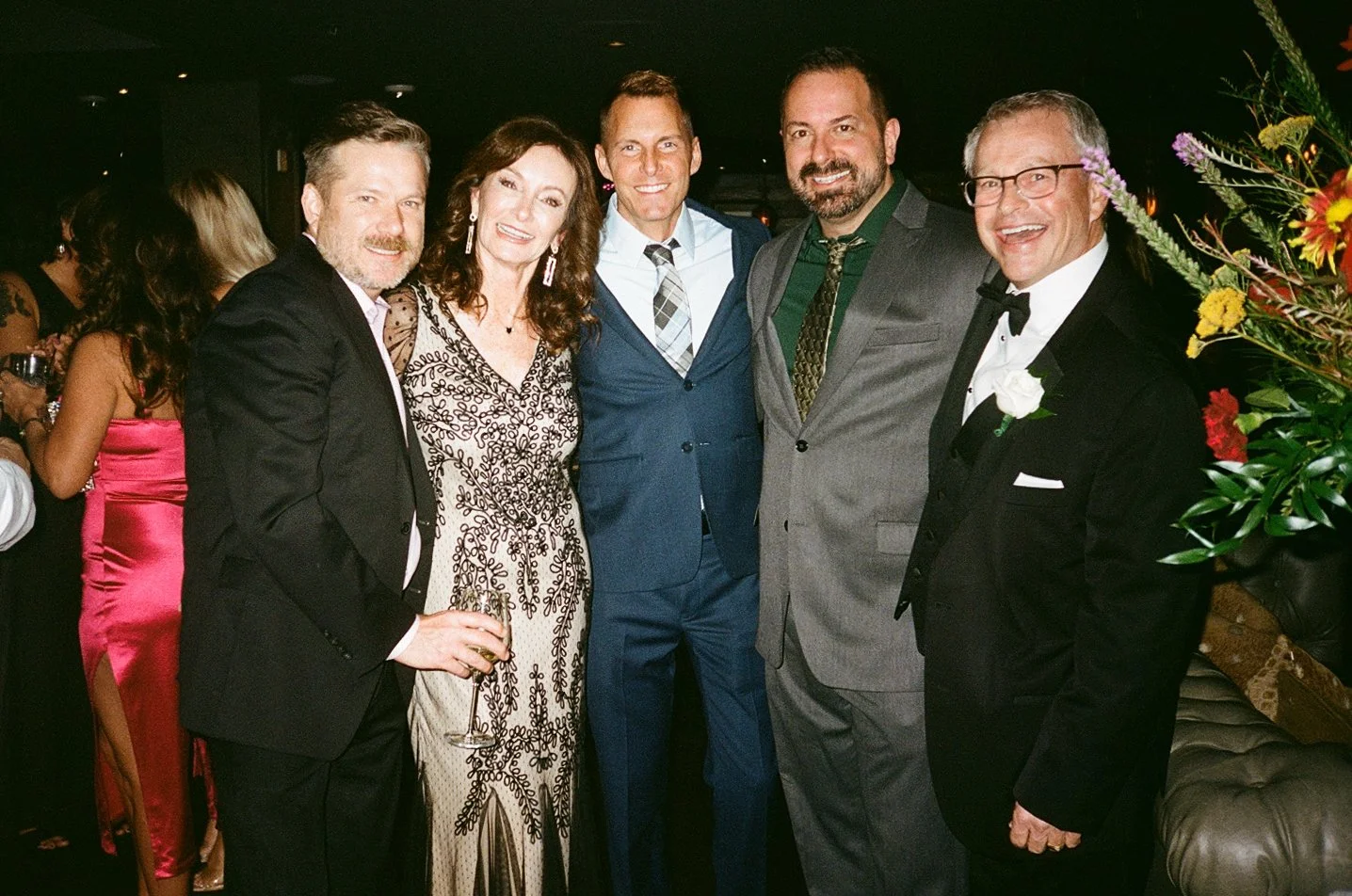 a couple poses with their friends after their 40th vow renewal at iveys hotel in charlotte north carolina